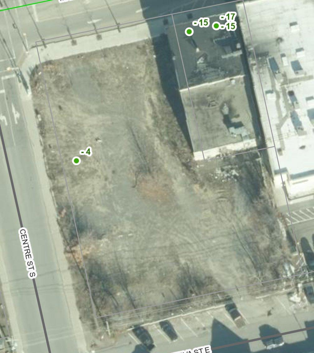Aerial view of the vacant Empire lot at Centre Street and Main Street in downtown Huntsville today — a cleared, bare gravel site.